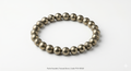 Pyrite bracelet for wealth and protection, natural money magnet stone jewelry on white background